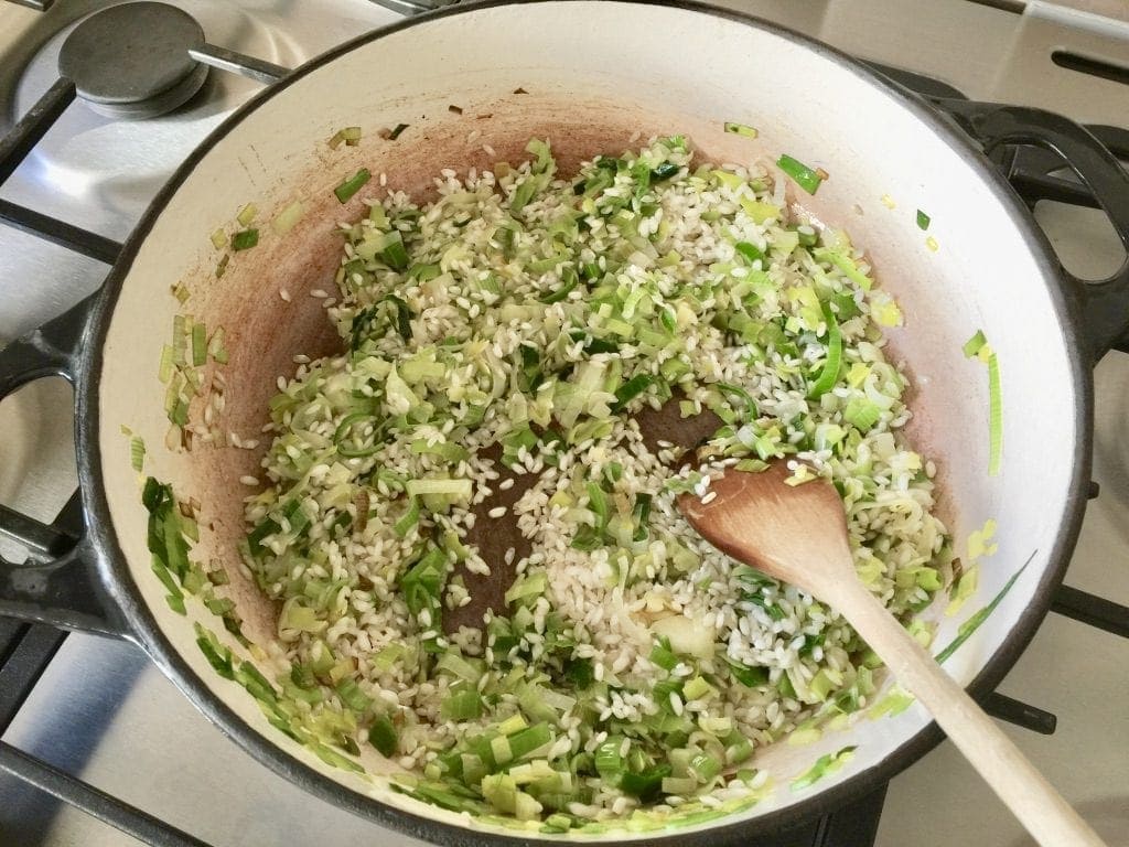 Rice and leeks in a pan.