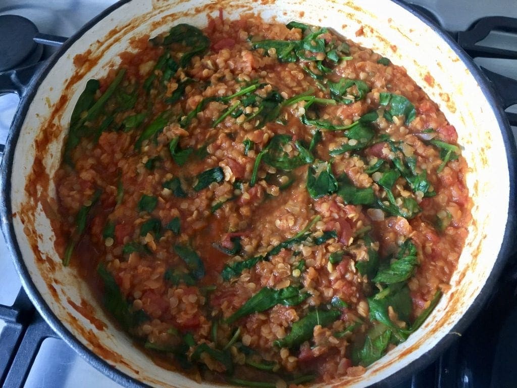 Finished lentil ragu with wilted spinach.