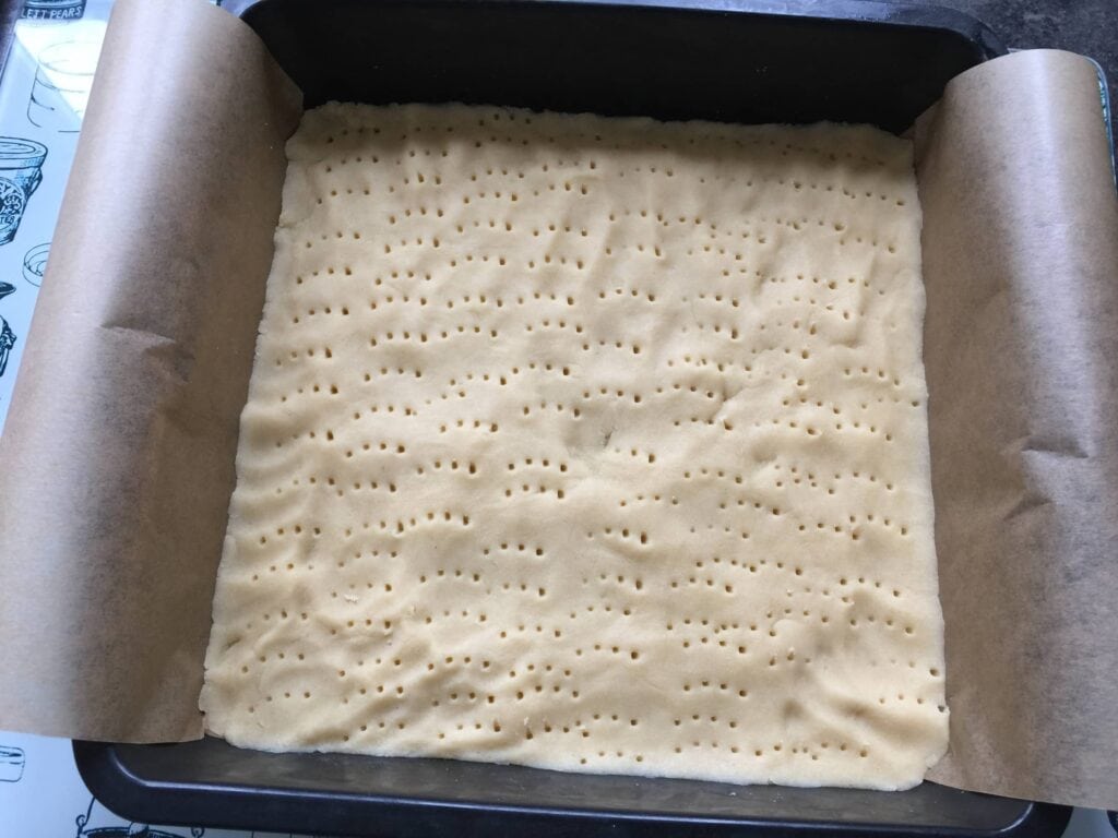 Shortbread base before baking pierced with a fork.
