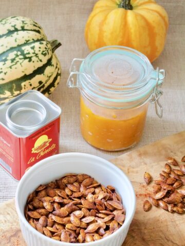 Roasted pumpkin seeds, pumpkin puree in a jar & paprika.