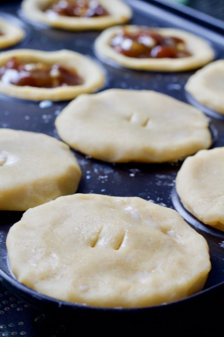 Close up of unbaked mince pie with pastry top on.