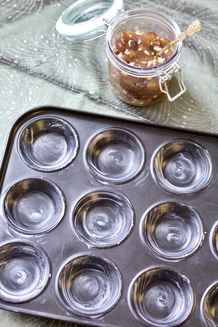 Empty buttered shallow tart tray.