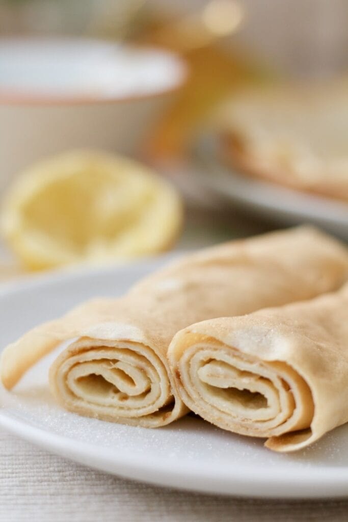 Close up of two rolled up pancakes.