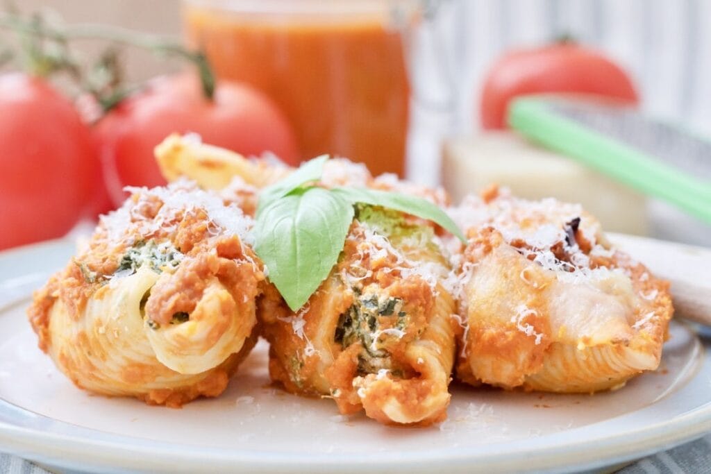 Close up of three pasta shells on a plate.