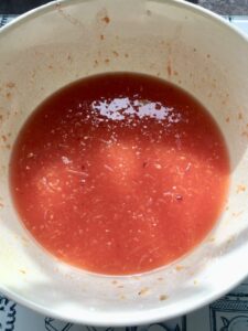 Blood orange sugar syrup in a bowl.