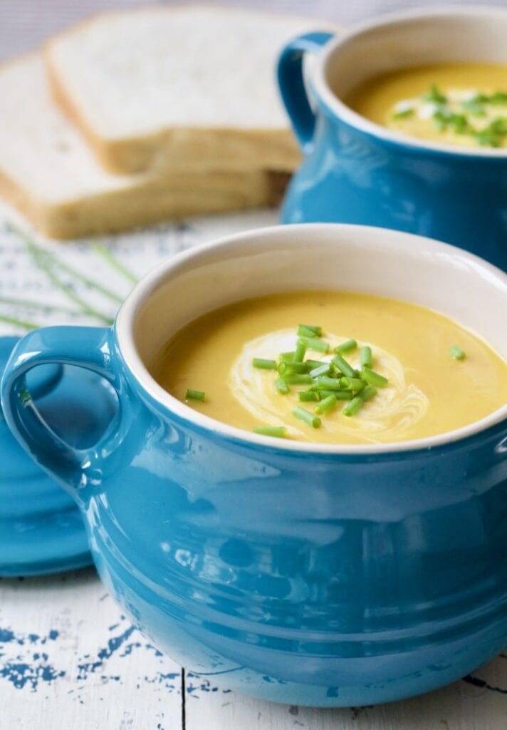 Soup in a blue bowl with garnishes.