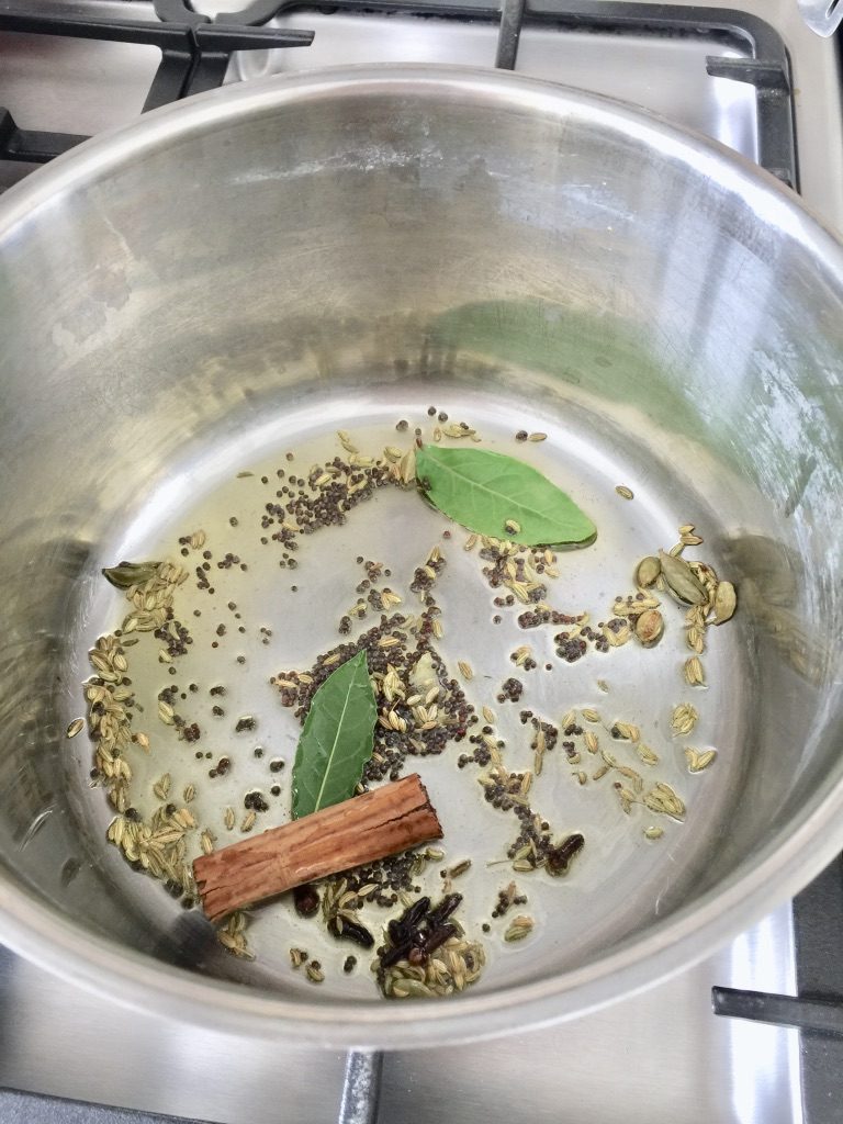 Frying herbs & spices in oil or butter.
