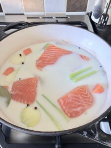 Fish and veg poaching in milk.