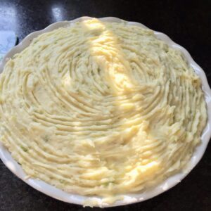 Mashed potato covered pie in a dish.