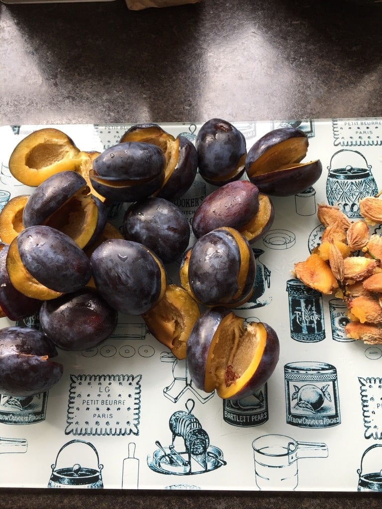 Halved plums with their stones removed.