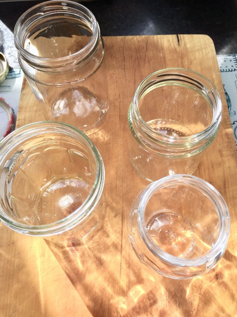 Clear jars on a wooden board.