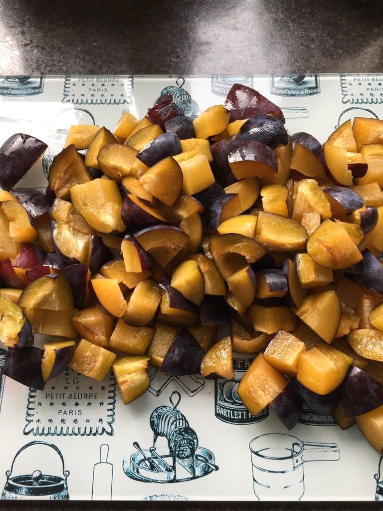 Chopped plums on the cutting board.