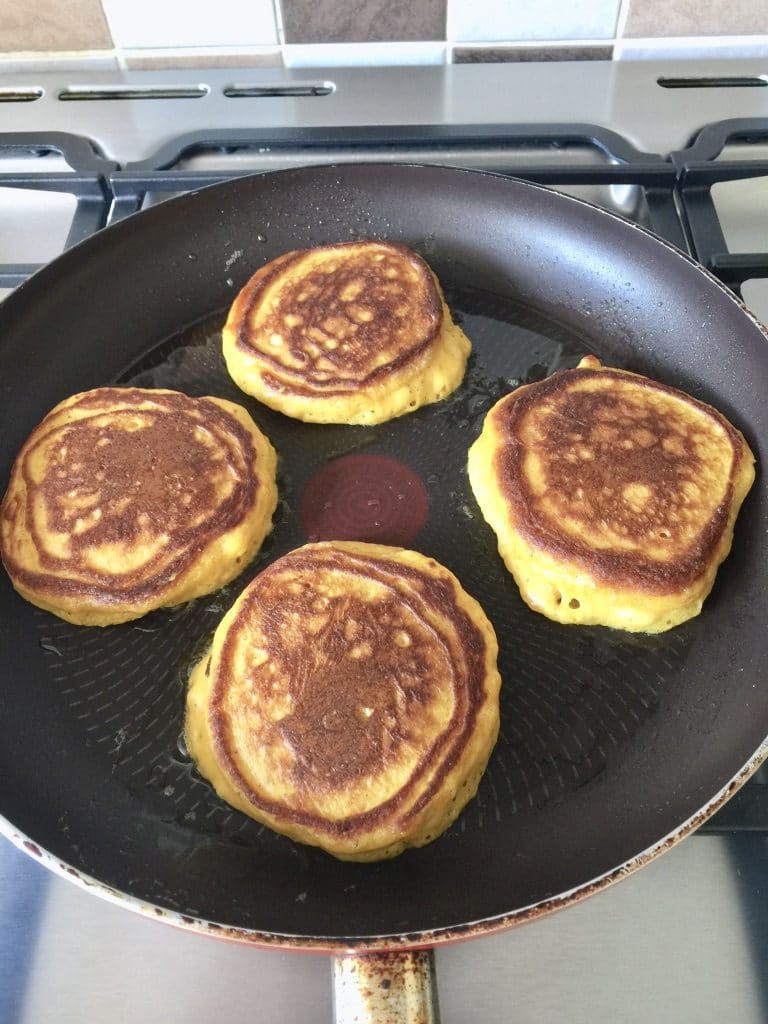 4 pancakes frying on the other side.