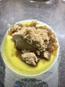 Sugar added to melted butter in a bowl.