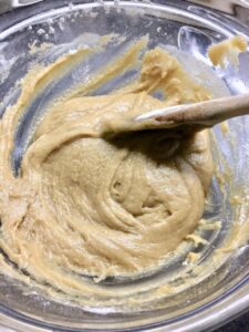 Cookie mix in a bowl with wooden spoon.