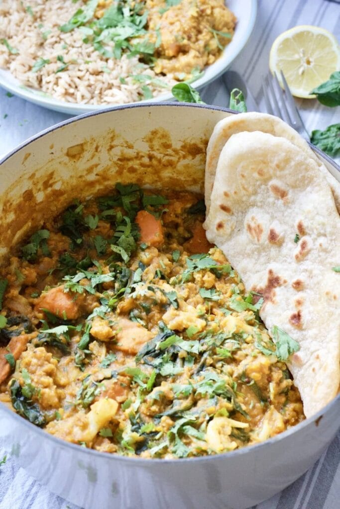 Easy Cauliflower & Lentil Curry - curry in a pot with some flat bread