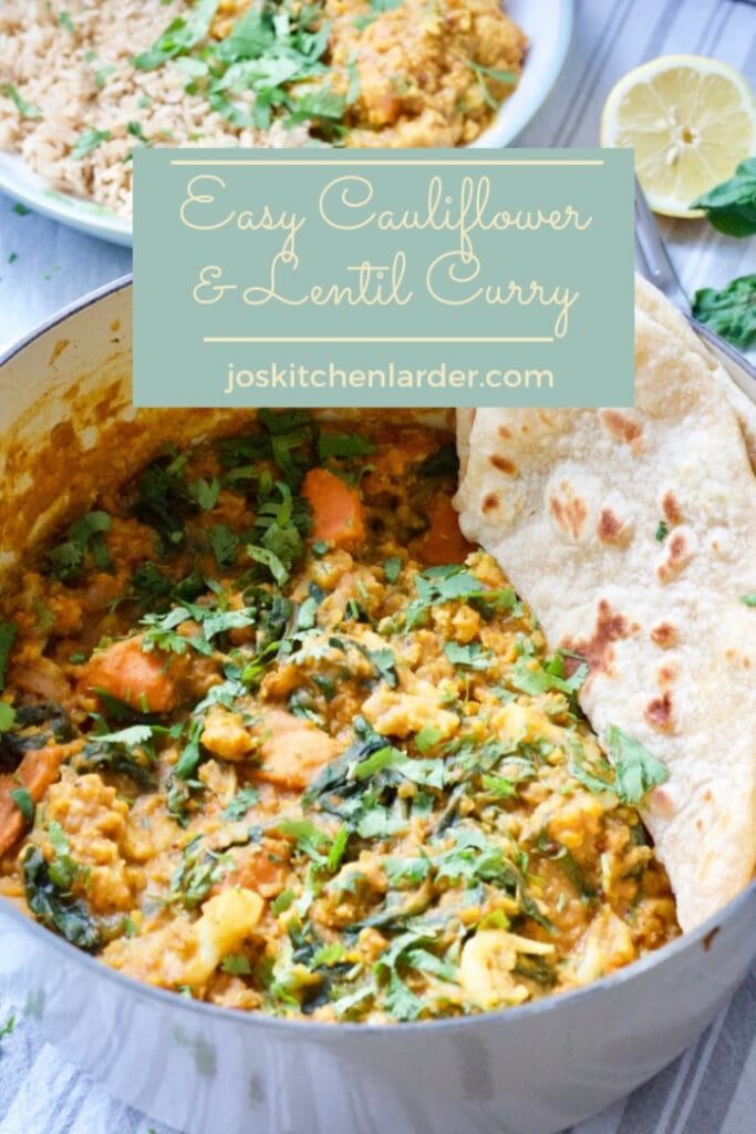 Cauliflower and lentil curry in a pot with some flat bread.