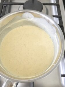 Egg yolk and cream mixture in a pan.