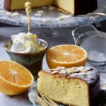 Gluten-Free Orange and Almond Cake slice with cake in the background