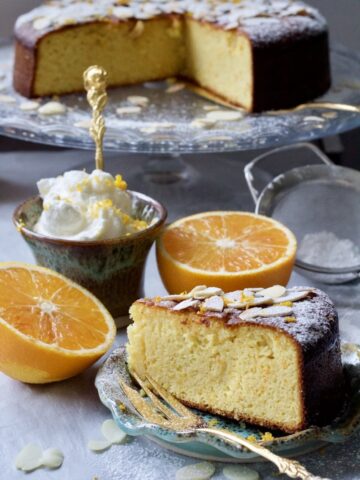 Gluten-Free Orange and Almond Cake slice with cake in the background