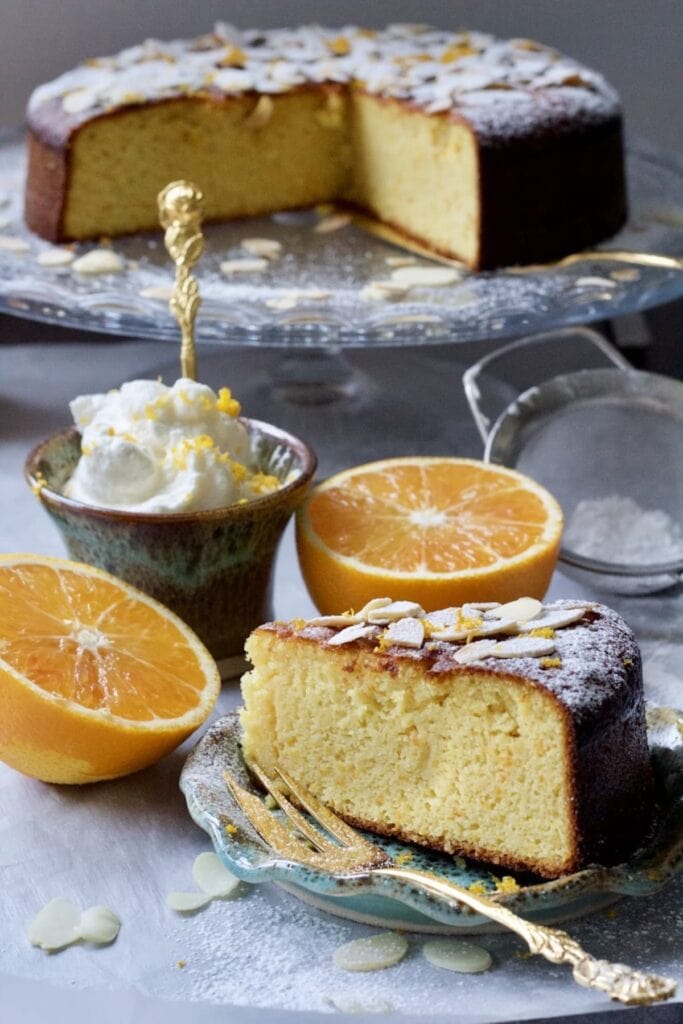 Gluten-Free Orange and Almond Cake slice with cake in the background