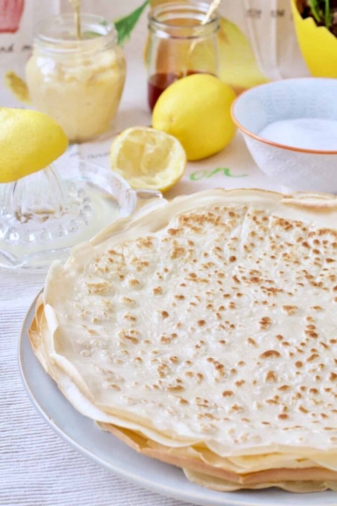 Pancakes piled up on a plate.