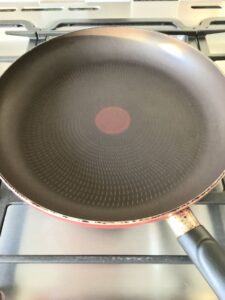 Frying pan on the hob ready to fry pancakes.