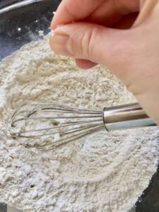 Adding pinch of salt to flour.