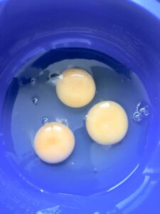 Three eggs in a bowl.