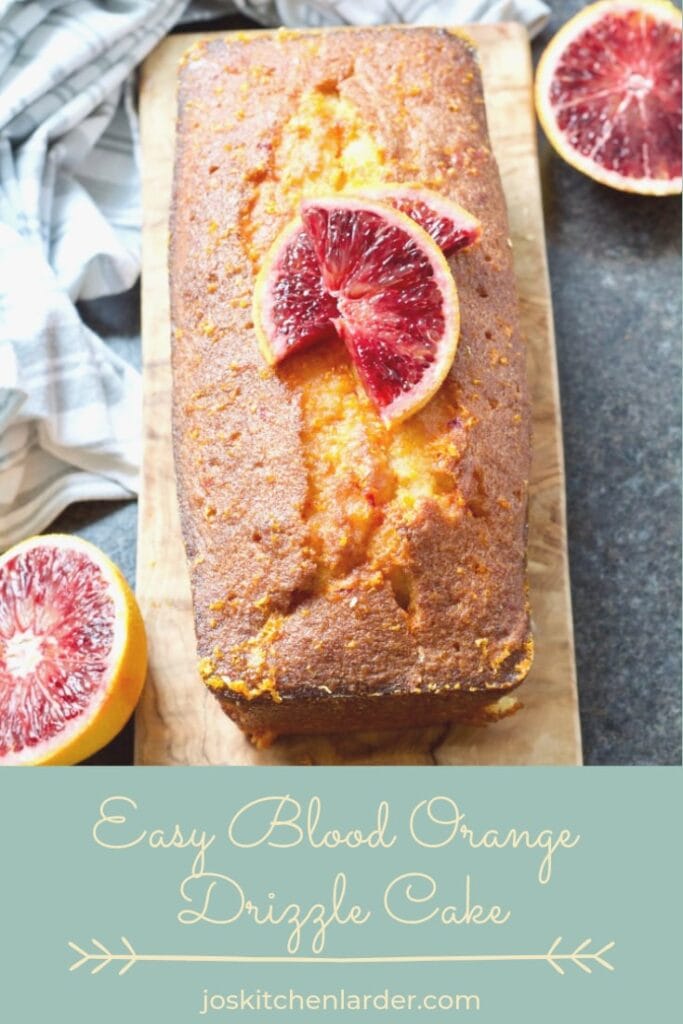 Easy Blood Orange Drizzle Cake on the board decorated with orange slices