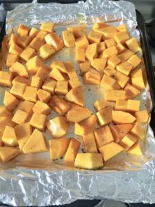 Easy Butternut Squash & Chorizo Gnocchi - chunks of butternut squash on the baking tray ready for roasting