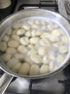 Easy Butternut Squash & Chorizo Gnocchi - gnocchi boiling in a pan of salted water