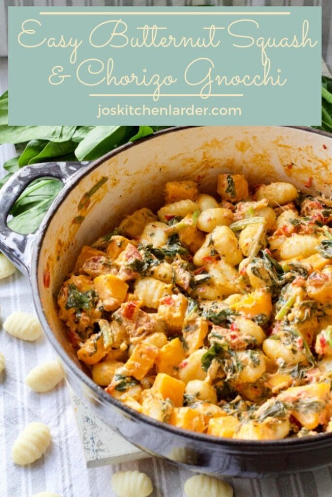 Easy Butternut Squash & Chorizo Gnocchi - close up of pan with ready made dish with some fresh spinach and uncooked gnocchi around it