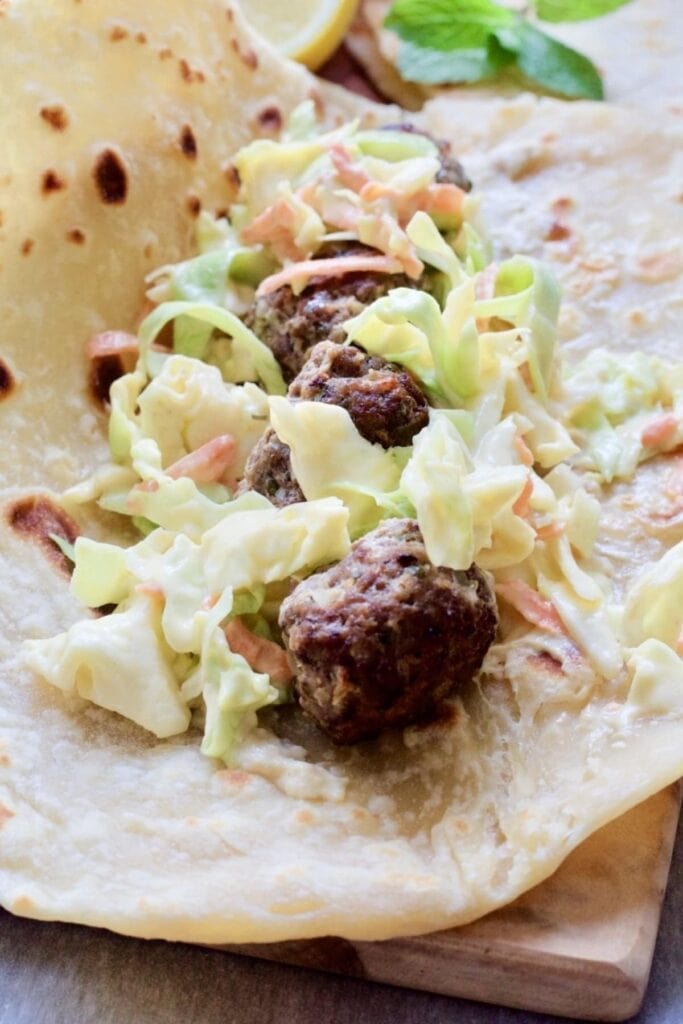 Easy Lamb Kofta Meatballs in a flatbread with coleslaw close up