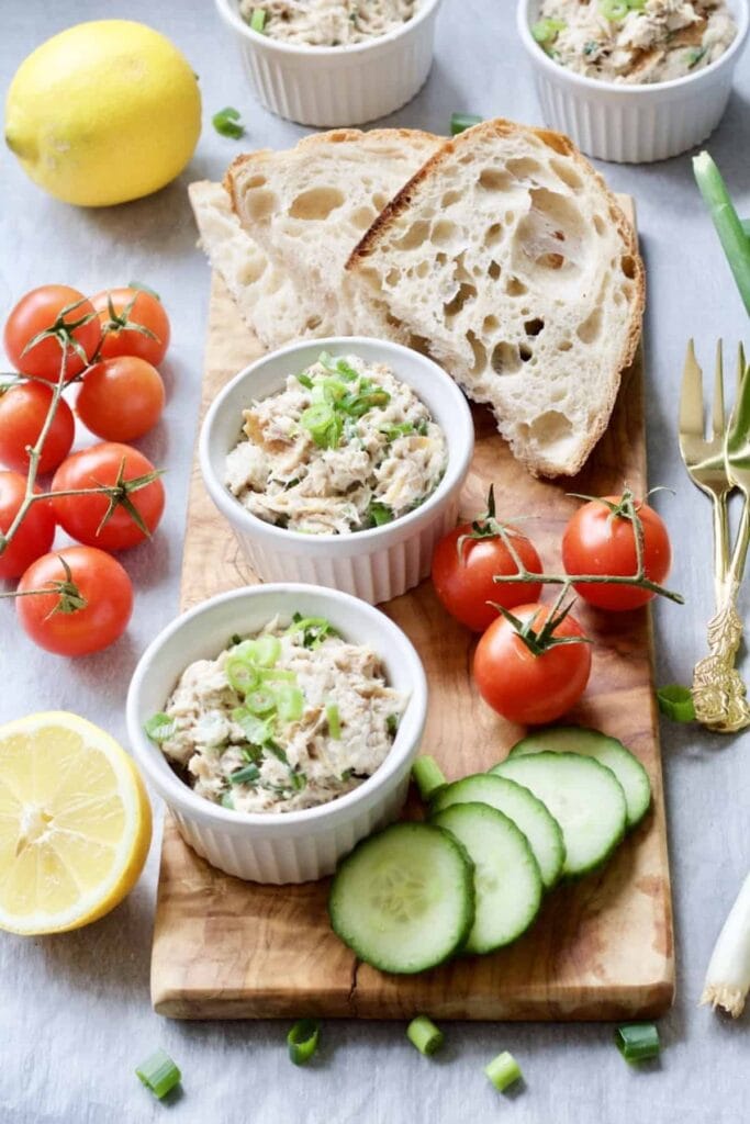 Smoked Mackerel Pate - pate in ramekins on serving board with bread and veg garnishes