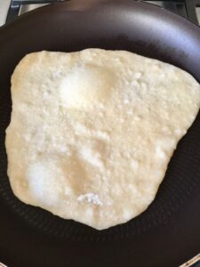 Easy Flatbread (No Yeast) in the frying pan with bubbles rising to the surface