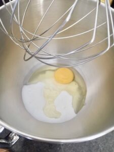 egg and sugar in a mixer bowl with balloon whisk