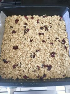 Flapjacks with cranberries in a baking tin