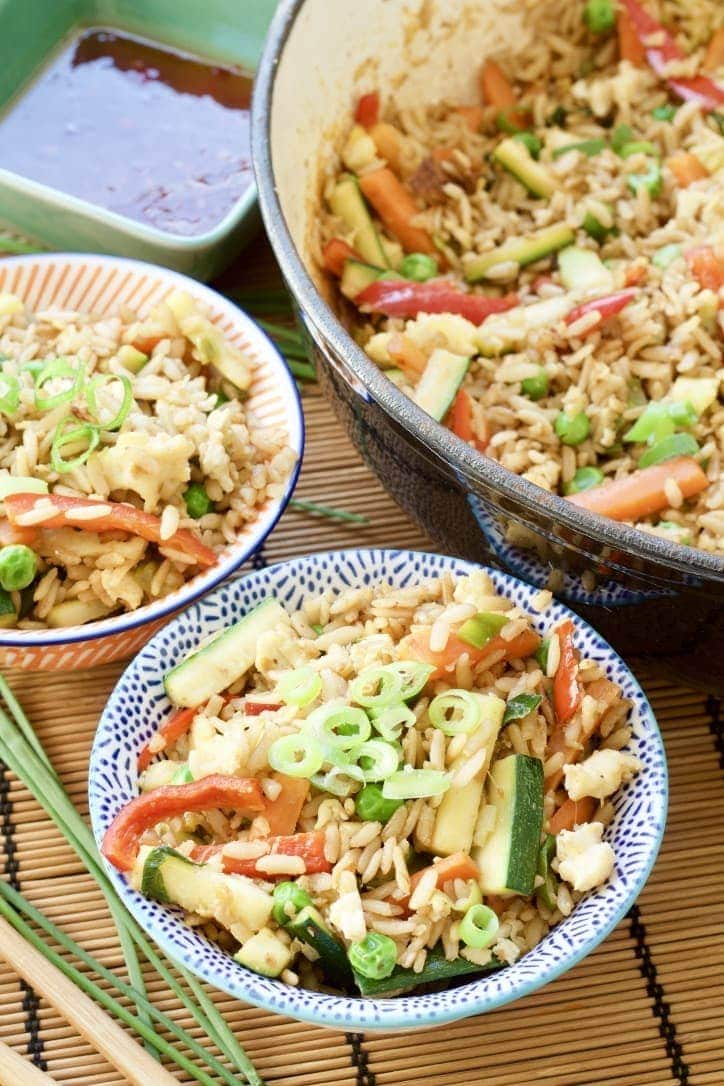 Vegetable Egg Fried Rice in bowls and in a pan