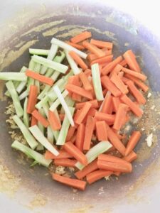 carrot and broccoli stalk matchsticks in a pan