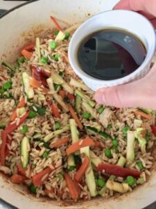 bowl with soy sauce over vegetable egg fried rice
