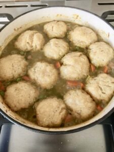 Wild Garlic Chicken Stew with Cheesy Dumplings in a pan