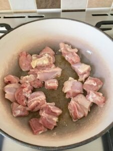 raw chicken pieces in a pan