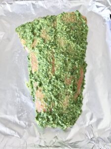 Salmon side covered in pesto