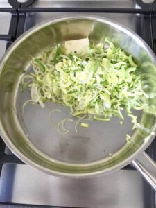 Sliced leeks and butter in a pan