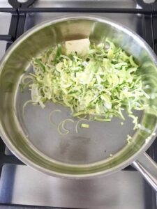 Sliced leeks and butter in a pan