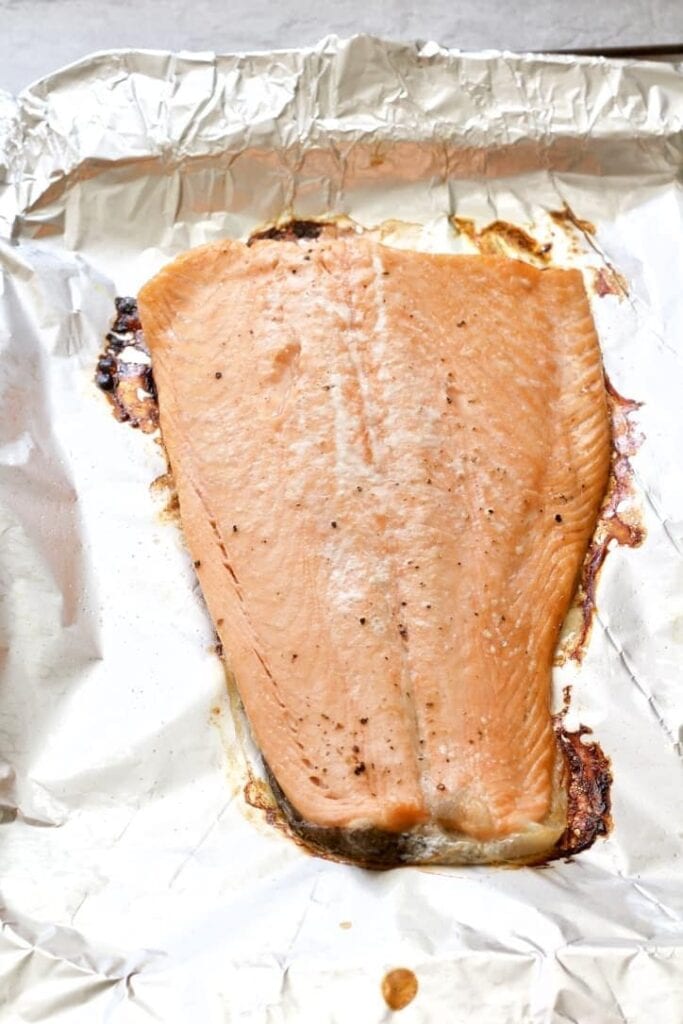 Cooked salmon fillet on a tray.