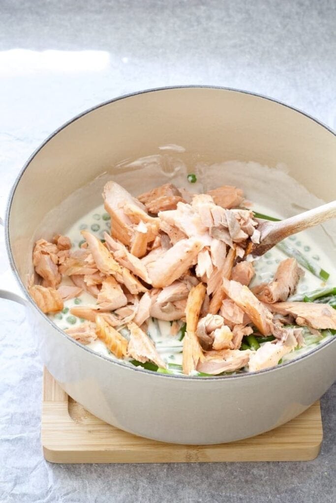 Pot with creamy sauce & flaked salmon.