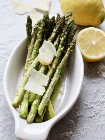 roasted asparagus in a dish with parmesan