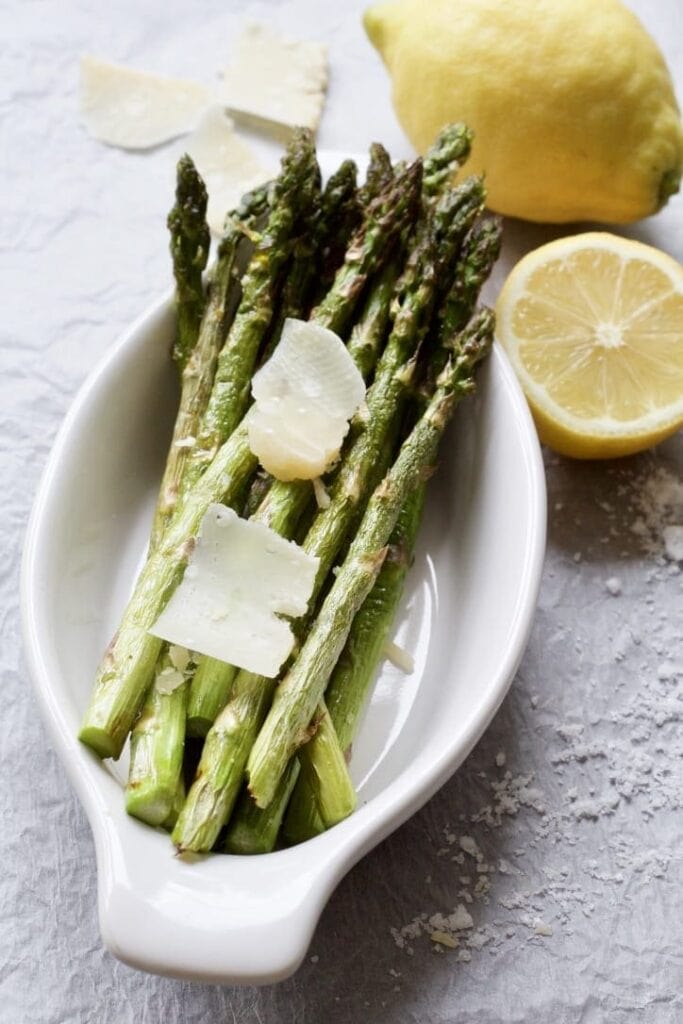 roasted asparagus in a dish with parmesan